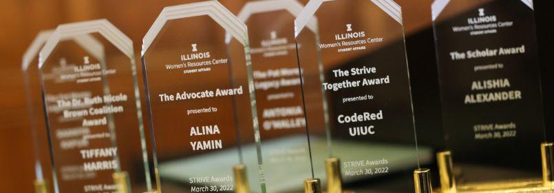 Closeup view of a row of acrylic Strive awards.